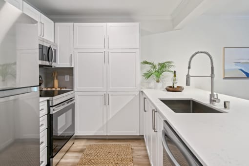 a white kitchen with white cabinets and a sink at Lakemont Orchard, Issaquah, WA 98027  