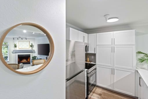 a mirror and a white kitchen with a fireplace at Lakemont Orchard, Issaquah, 98027  