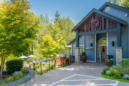 a patio in front of a blue building with a porch at Lakemont Orchard, Issaquah, 98027  