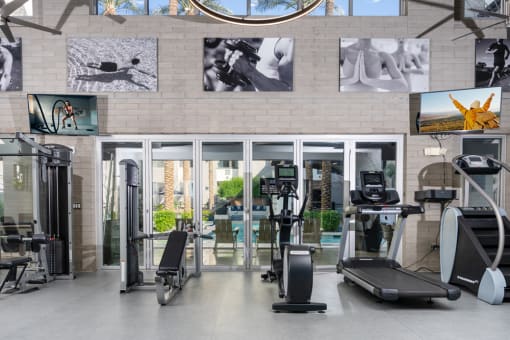 Gym with cardio equipment and pictures on the wall at Level at Sixteenth, Phoenix, AZ, 85014