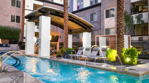 Swimming pool with a fountain and lounge chairs at Level at Sixteenth, Arizona