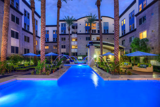Phoenix AZ Apartments- Exterior View of the Back of Level at Sixteenth Building Featuring Pool Lit at Night