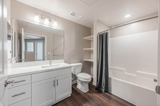 A white bathroom with a sink, toilet, and bathtub.