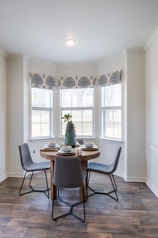 Dining Area With Circle Table, Spacious Windows, And Table Decorations at McDermott Place, Plano, 75025