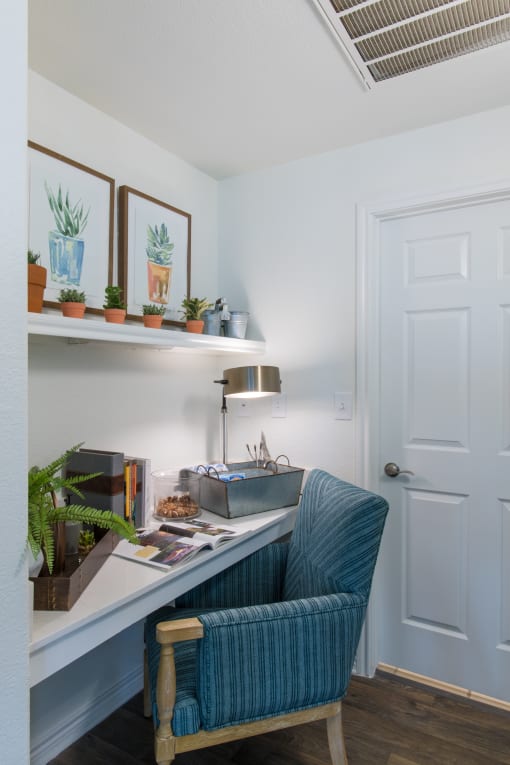 Apartments In Plano, TX - McDermott Place - Study Area With Desk, Blue Chair, And Study Lamp