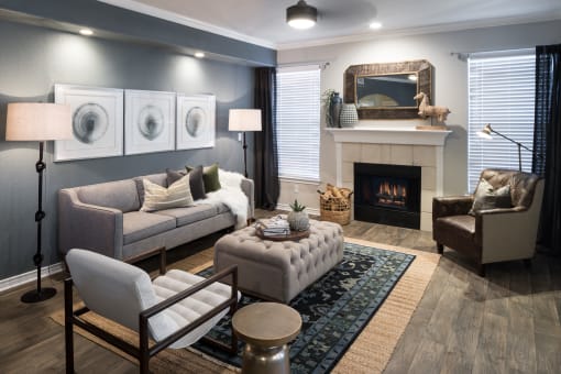 a living room with a fireplace and couches at McDermott Place, Texas