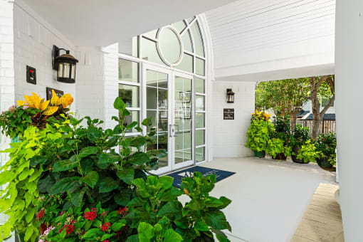 a large white building with a large glass door at McDermott Place, Texas 75025