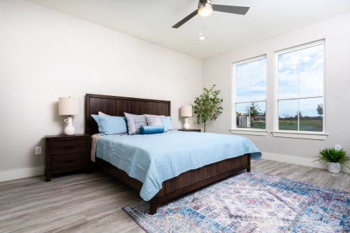 mihir taylor model bedroom with a bed and a ceiling fan