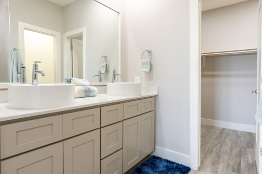 model bathroom with two sinks and a large mirror