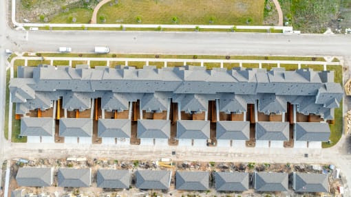 an aerial view of a row of roofs in a parking lot