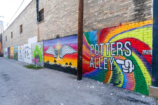 a mural that says potters alley on a brick wall