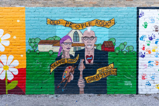a mural on the side of a brick wall