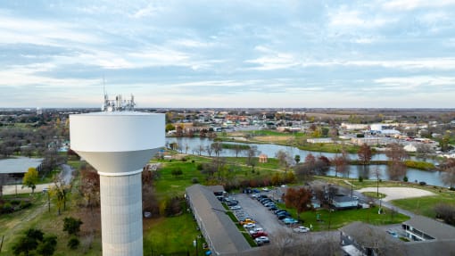an aerial view of a water tower overlooking a city with a river
