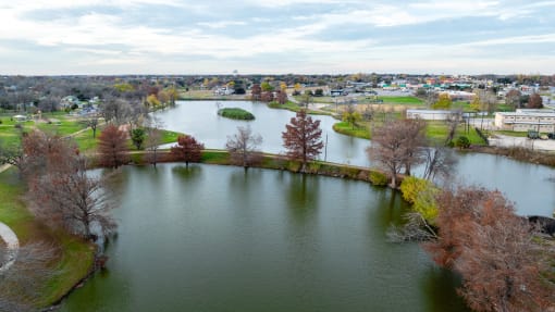 an aerial view of a lake with a city in the background
