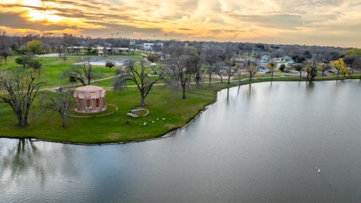 an aerial view of a park next to a body of water