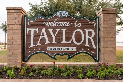 the welcome sign at the entrance to the city of taylor texas