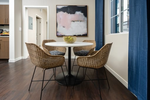 a dining area with a table and chairs and a painting on the wall at Miro at the Parc, Nevada 89074