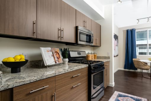a kitchen with wooden cabinets and stainless steel appliances and granite counter tops at Miro at the Parc, Nevada
