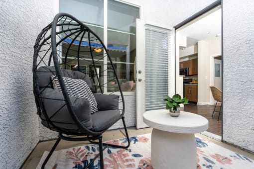 a living room with a black egg chair and a white table at Miro at the Parc, Nevada