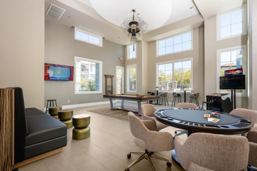 a clubhouse with a poker table and chairs and a television at Miro at the Parc, Nevada