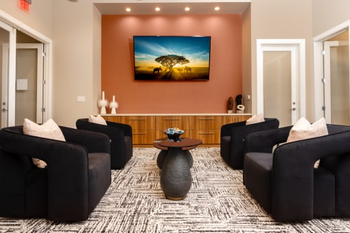 a living room with couches and a table with a painting on the wall at Miro at the Parc, Henderson
