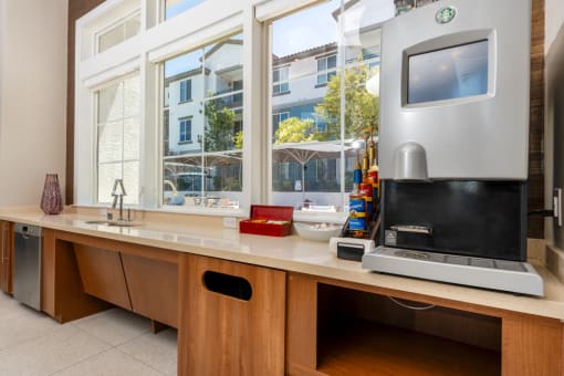 a kitchen with a counter with a microwave and a window at Miro at the Parc, Henderson, 89074