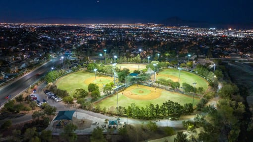 an aerial view of baseball fields at night at Miro at the Parc, Henderson, NV