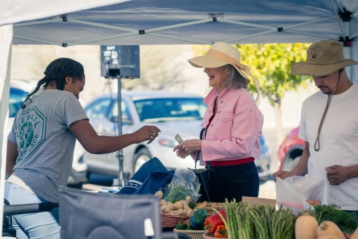 people buying food at a farmers market at Miro at the Parc, Henderson