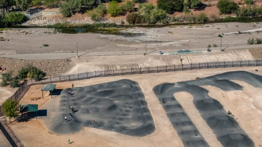 an aerial view of a bike park with ramps and a river at Miro at the Parc, Henderson, Nevada