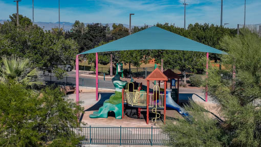a playground at a park with a green roof at Miro at the Parc, Henderson, Nevada