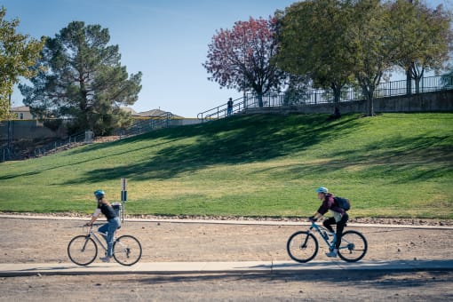 two people riding bikes at the park at Miro at the Parc, Henderson, NV 89074