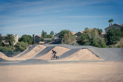 person riding a bike at the bike park at Miro at the Parc, Henderson