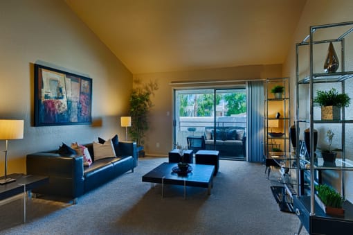 Living Room with Carpeting, Beige Walls, and Sliding Glass Patio Doors at Monaco at McCormick Ranch, Scottsdale, AZ