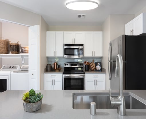 kitchen with white cabinets and stainless steel appliances at Montrachet Apartments, California, 94558