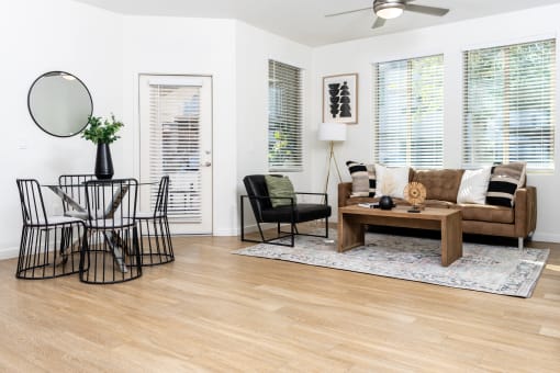Living room and dining area with ceiling fan and balcony door at Monument, Chandler