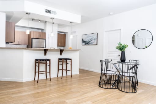 a living room with a table and chairs and a kitchen at Monument, Chandler, 85224