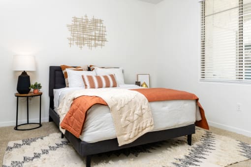 Apartments for Rent Chandler, AZ - Monument - Bedroom with Plush Carpeting, Window, and Full-Size Bed.