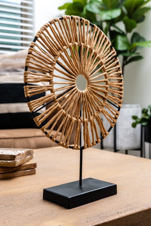 a decorative brass fan sculpture on a table