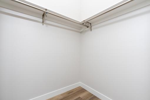 A white wall with a silver bar on top. at Nola 624, West Covina  
