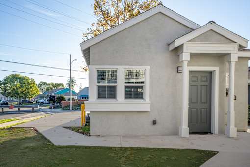 A small white house with a grey door and windows. at Nola 624, West Covina  