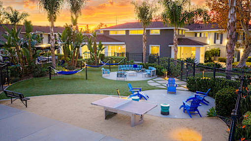A backyard with a hammock, table, and chairs. at Nola 624, West Covina, CA