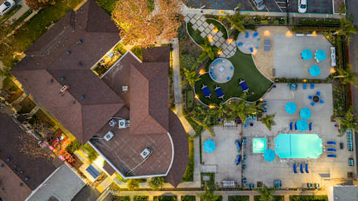 A bird's eye view of a residential area with houses, a pool, and a playground. at Nola 624, West Covina, 91790