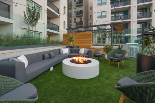 Outdoor Community Lounge With Firepit, Chairs, Tables, And Maintained Landscaping In the Heart Of The Apartment Building. at NoMa Apartments, Walnut Creek, 94596