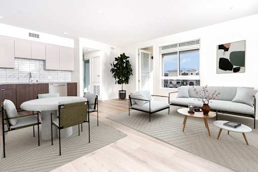 A modern living room with a dining table and chairs.