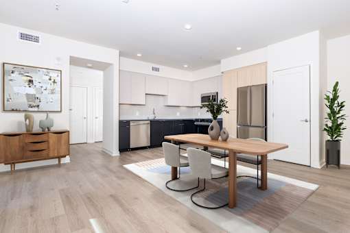 A modern kitchen with a dining table and chairs.