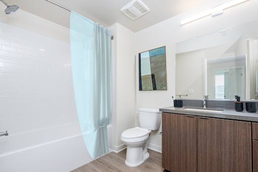 A white toilet sits next to a sink in a bathroom.