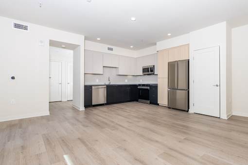 A kitchen with white cabinets and a black countertop.