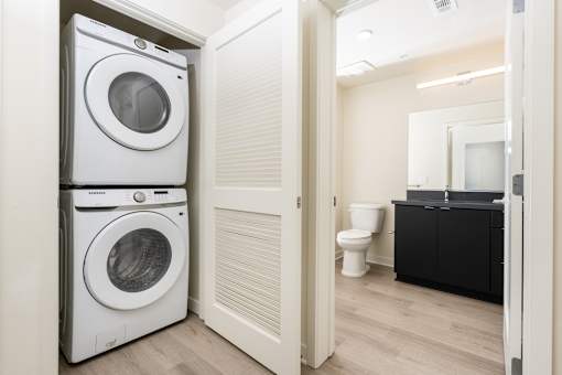 A white washing machine and dryer in a small laundry room.