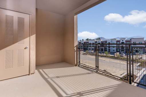 A balcony with a view of a residential area.