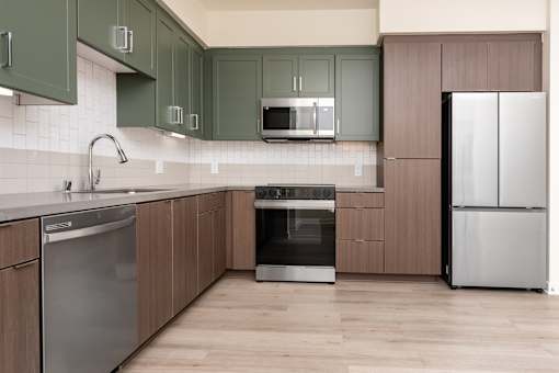 A kitchen with wooden cabinets and stainless steel appliances.